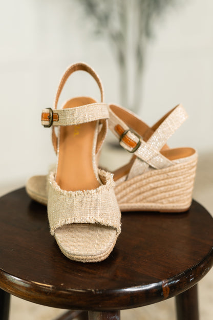 Arnold natural linen wedges showing frayed canvas upper, peep toe, and adjustable strap.
