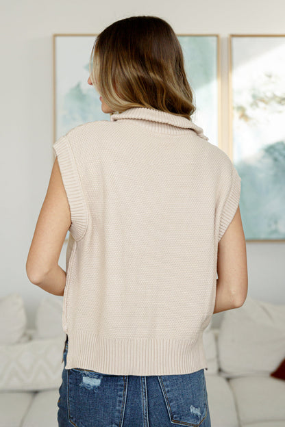Back view of Ashton Cable Knit Vest in ivory with drop shoulder and ribbed hem detail.