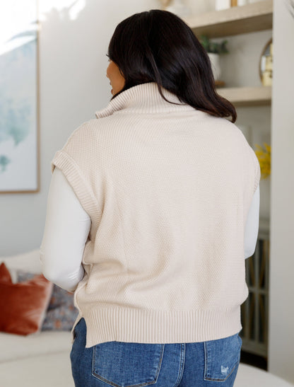 Back view of plus size Ashton Cable Knit Vest in ivory with ribbed hem and exposed seam detail.