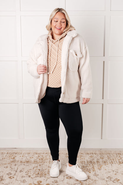 Plus size full body view of Dalia Checkered Hoodie paired with fuzzy jacket