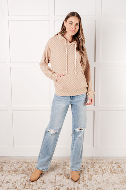 Full body view of model wearing Dalia Checkered Hoodie in khaki with jeans and boots.