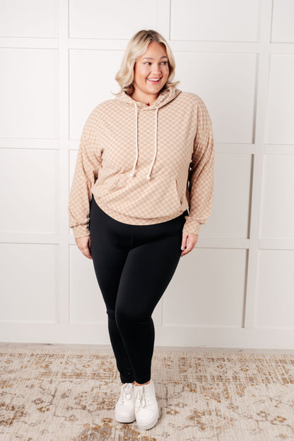 Plus size full body view of Dalia Checkered Hoodie in khaki paired with leggings and sneakers.