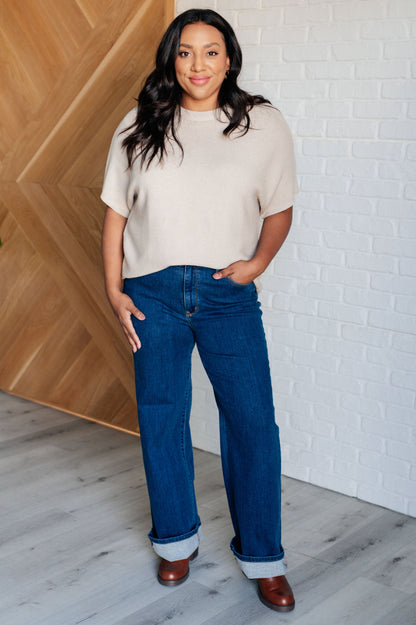 Plus size model wearing taupe Avril Dolman Sleeve Knit Top, front view.