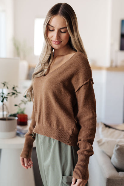 Side angle of Bambi V-Neck Sweater in Mocha highlighting exposed seams and v-neckline.