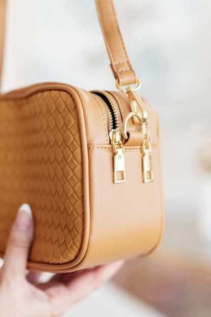 Side detail of Golden Hour Crossbody showing woven vegan leather texture and structured shape.
