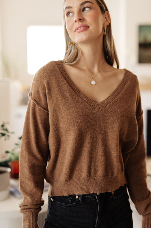 Model wearing Bambi V-Neck Sweater in Mocha with cropped length and dropped shoulder design.