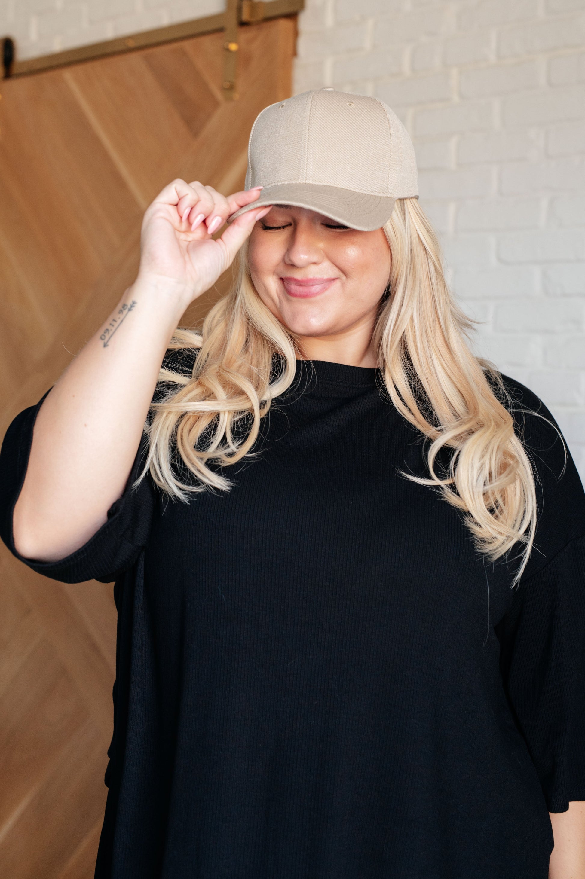 Khaki cap with an adjustable Velcro strap.