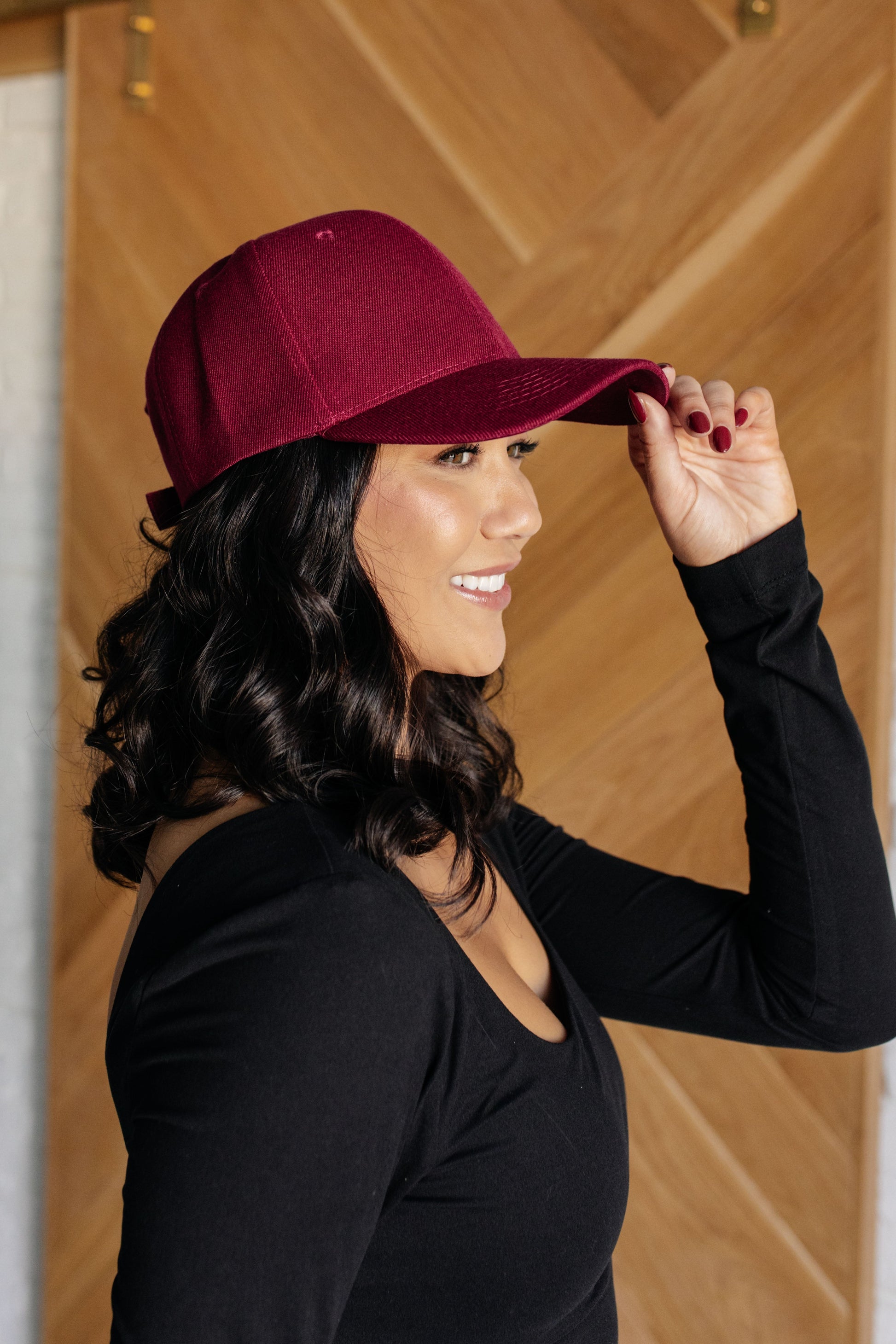 Wine colored cap with an adjustable Velcro strap.