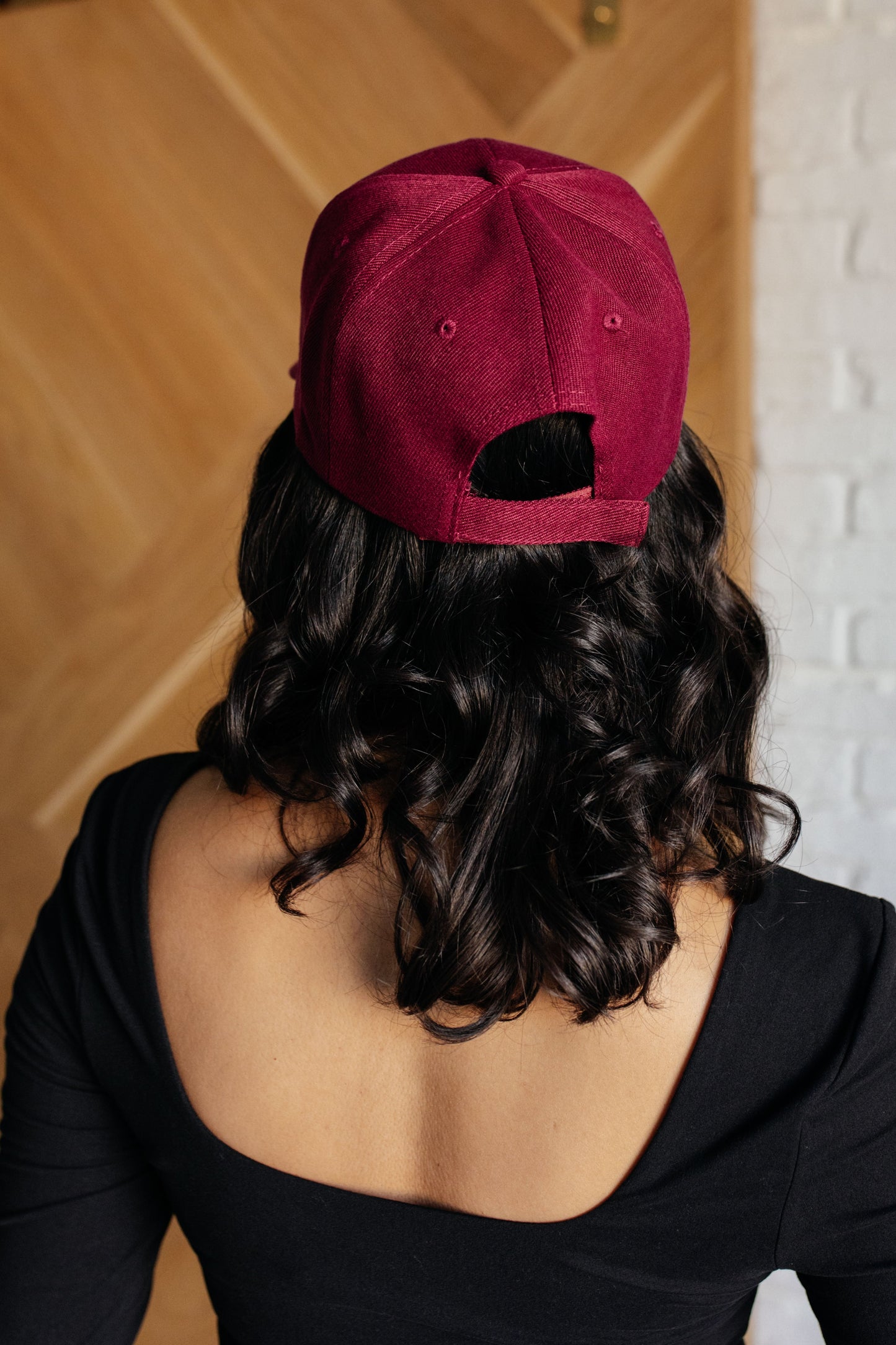 Wine colored cap with an adjustable Velcro strap.