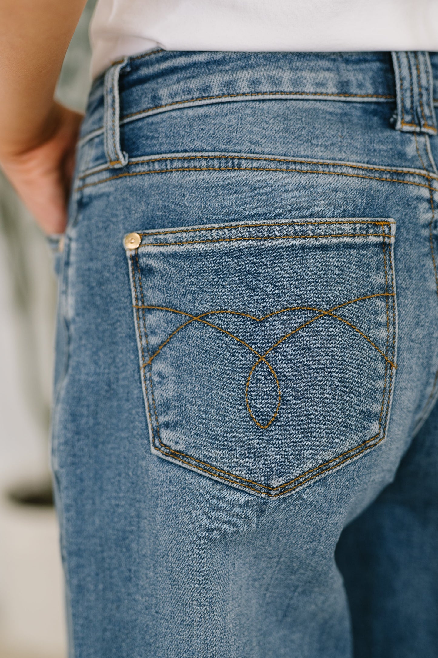 Close-up of back pocket on Bella High Waist Soft Barrel Jeans with stitch-through detail in medium wash denim.