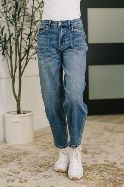 Front view of Bella High Waist Soft Barrel Jeans in medium wash with stitch-through pockets and flattering high-rise fit.