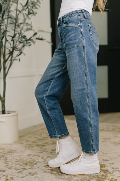 Side view of Bella High Waist Soft Barrel Jeans showing soft barrel silhouette and high-rise fit in medium wash.