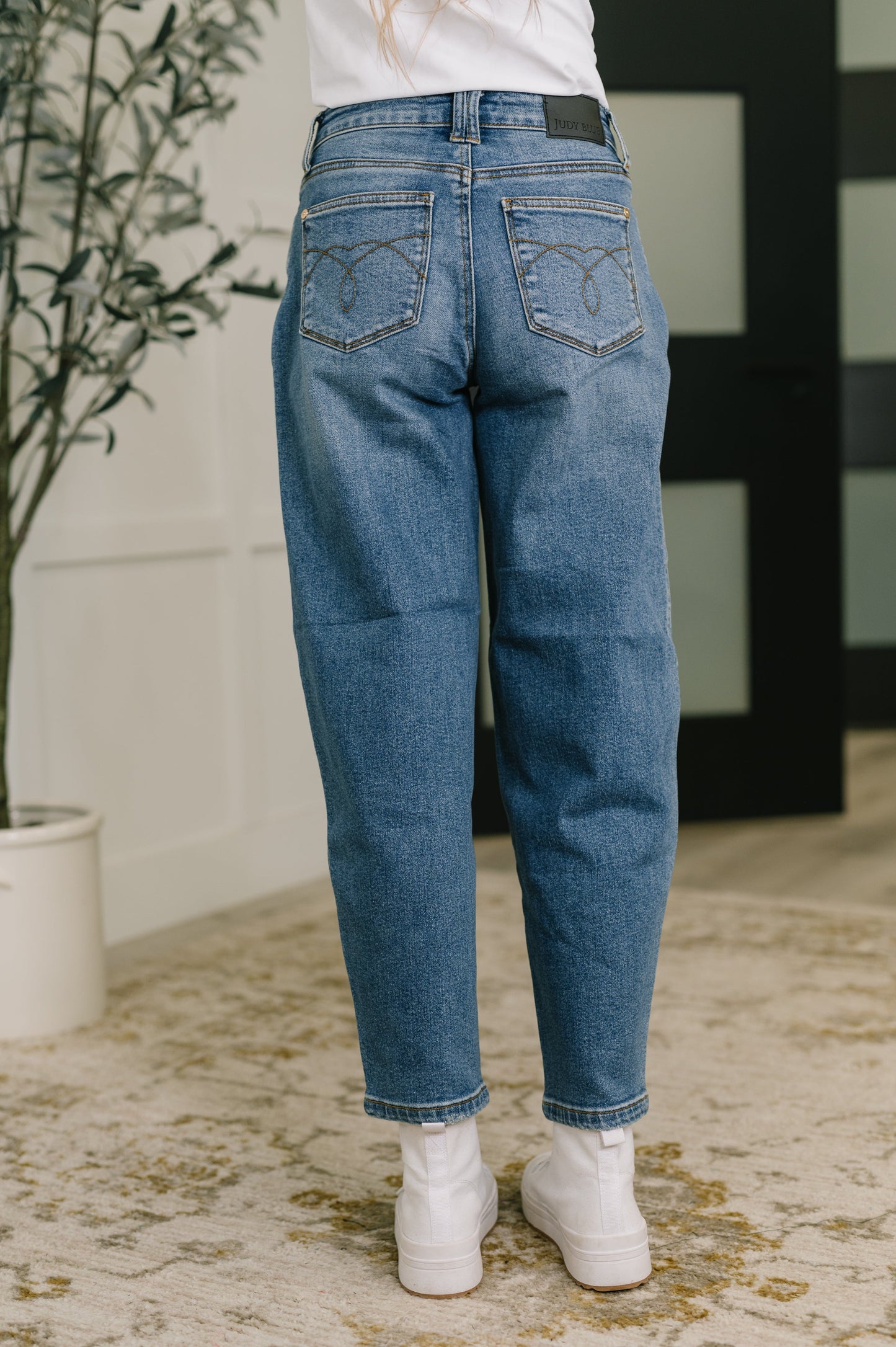 Back view of Bella High Waist Soft Barrel Jeans in medium wash with high-rise waist and relaxed barrel silhouette.