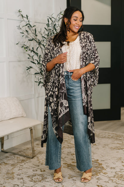Model wearing Bella Vida Open Front Floral Print Kimono black floral with flowy silhouette.