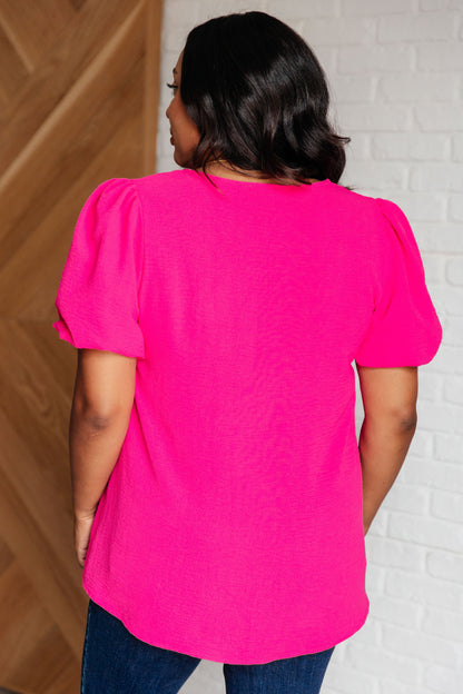 Back view plus size Belle Puff Sleeve Blouse in crinkle woven fabric with vibrant hot pink color.