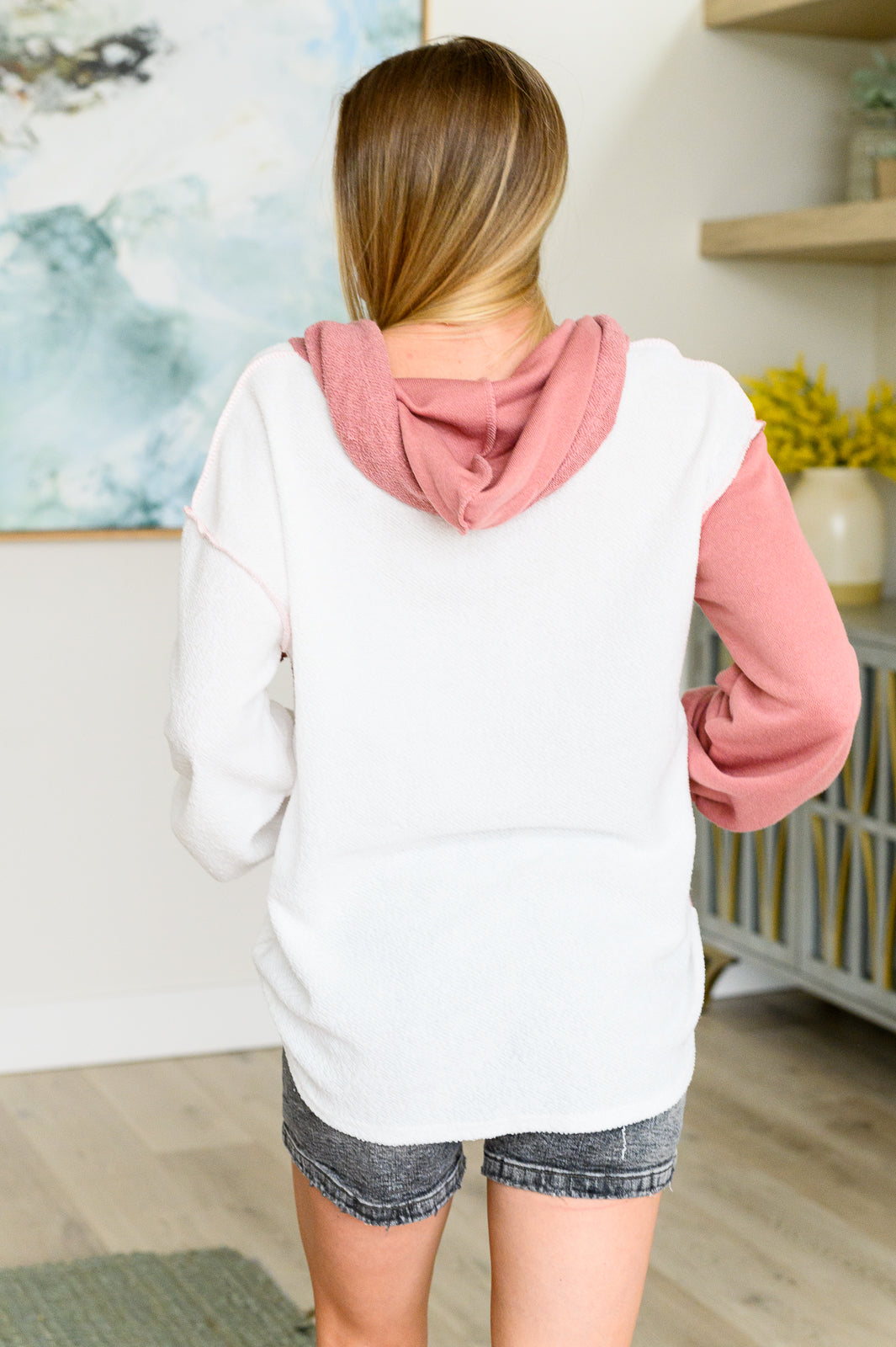 A cozy color block hoodie made from French terry fabric with a drawstring hood, long sleeves, and a relaxed fit.