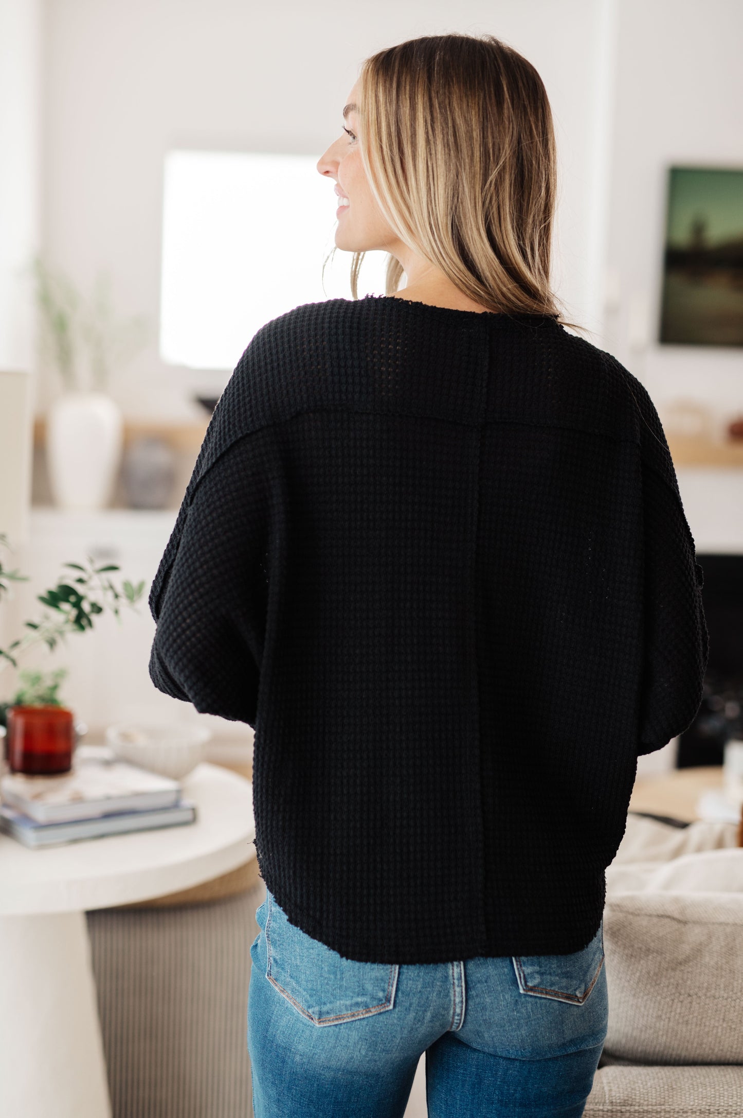 Back view of Bea Black Waffle Knit Henley Top with round neckline and cozy silhouette.