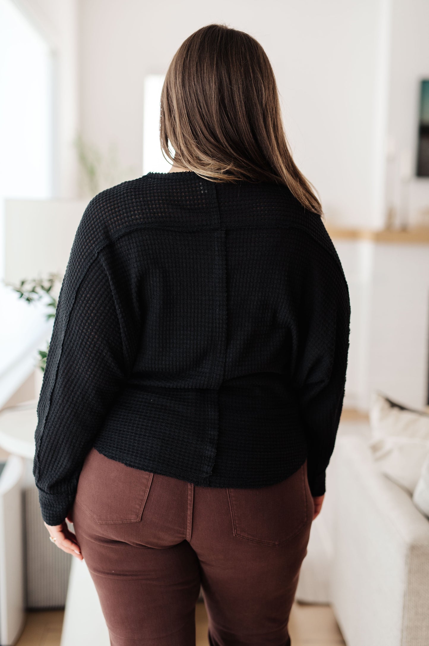 Back view of plus size Bea Black Henley Top with long sleeves and round neckline design.
