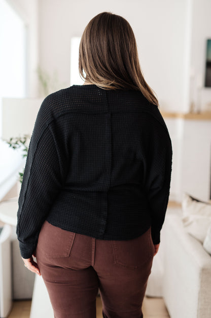 Back view of plus size Bea Black Henley Top with long sleeves and round neckline design.