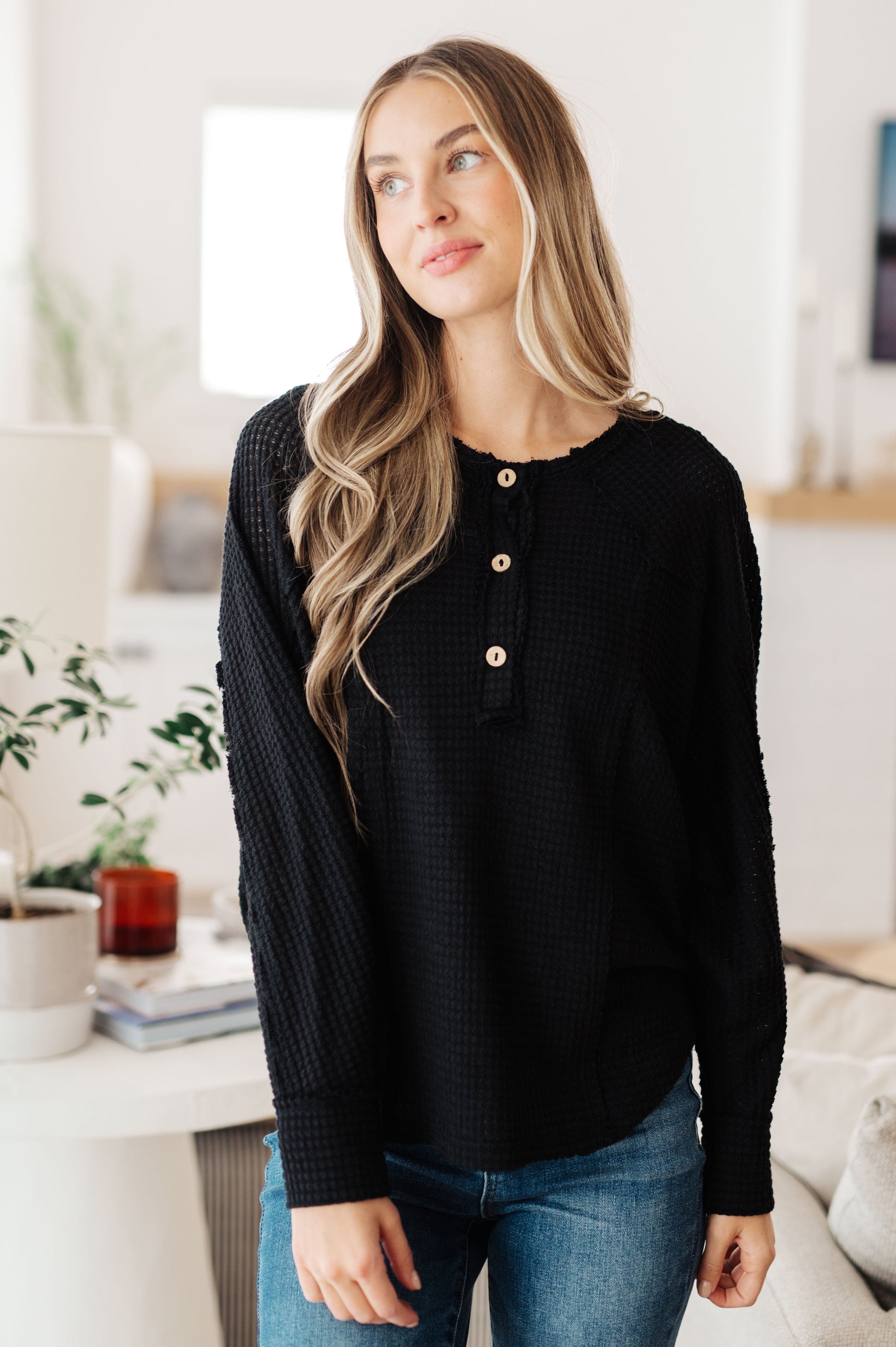 Front view of Bea Black Waffle Knit Henley Top with wooden buttons and raw seam detail.