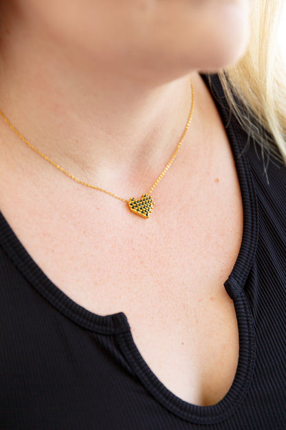 Front view of Bianca Checkered Heart Necklace with green faceted stones and gold-plated chain.
