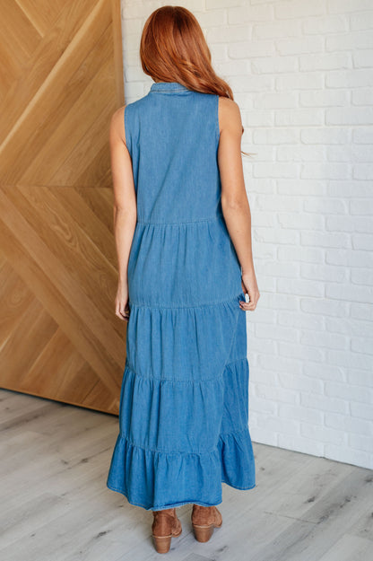 Back view of Bindy Denim Maxi Dress with tiered chambray design and flowy silhouette.