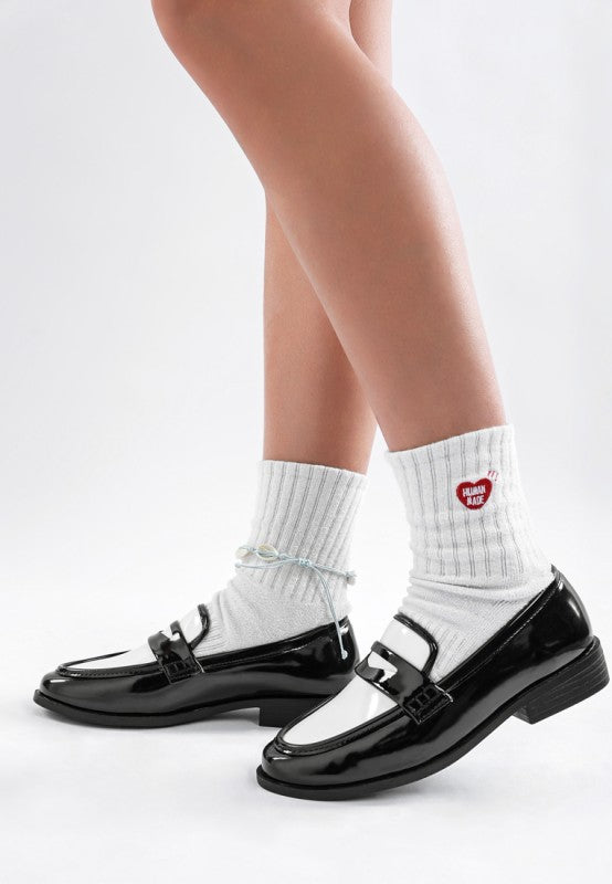 Side view of Bugle Duo Tone loafers showing sleek low block heel and patent shine