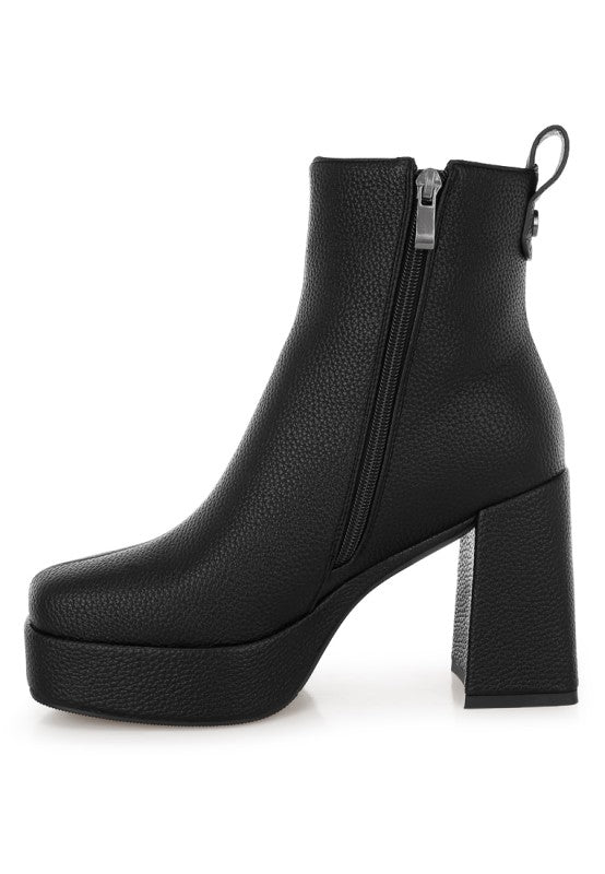 Side angle of black Poulin Chelsea Boots with zipper closure and pull tab for easy wear.