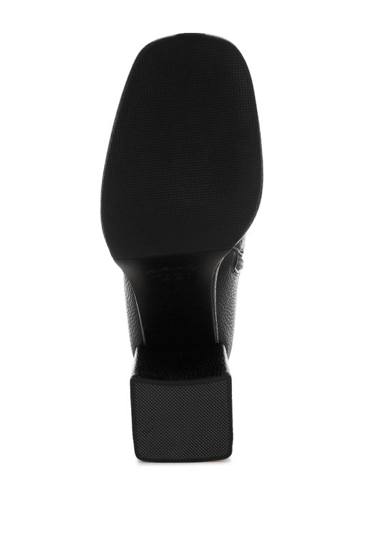 Bottom angle of black Poulin Chelsea Boots showcasing heel and sole.