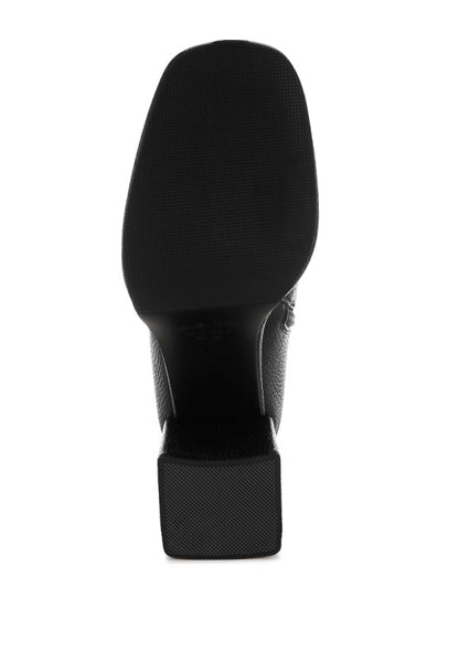 Bottom angle of black Poulin Chelsea Boots showcasing heel and sole.