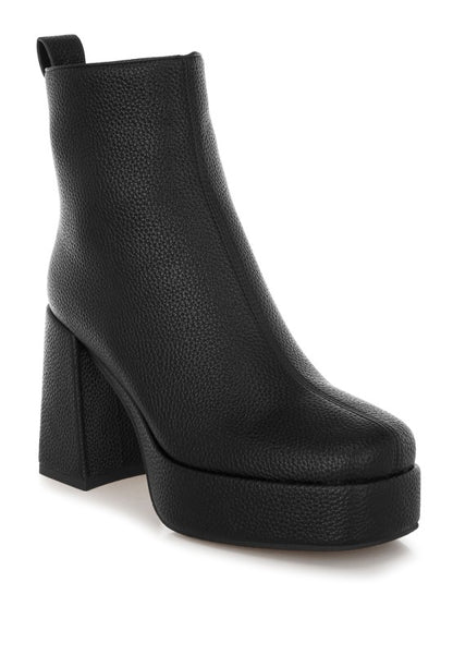 Black Poulin Chelsea Boots angled view with faux leather shine and block heel elevation.