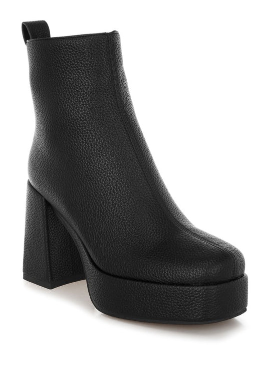 Black Poulin Chelsea Boots angled view with faux leather shine and block heel elevation.