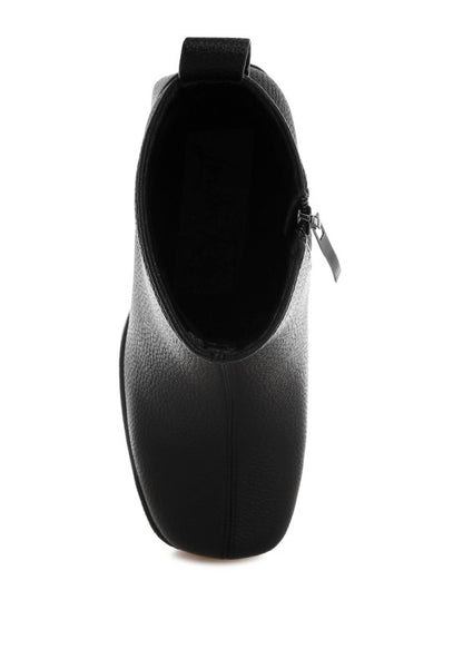 Top angle of black Poulin Chelsea Boots showcasing zipper closure and polished finish.