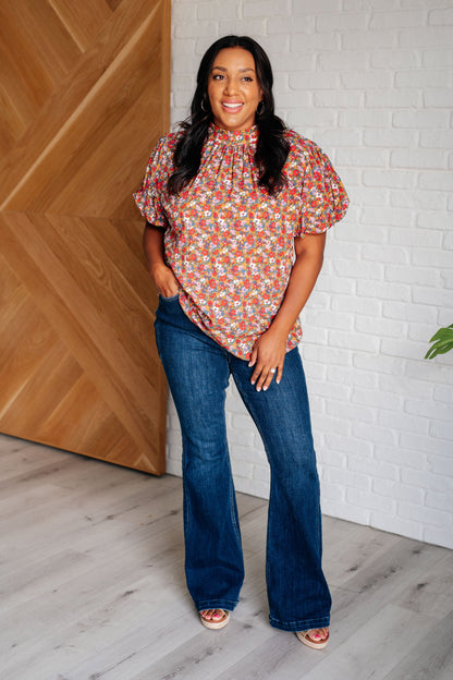 Bohemian plus size blouse in floral print with gathered neckline and cased elastic sleeve cuffs.