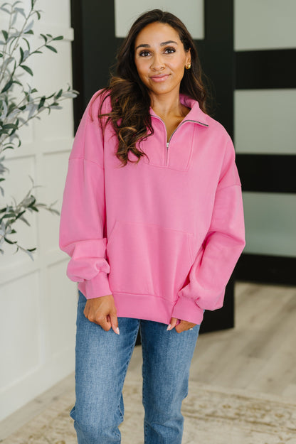 Model wearing Clarice Pink Half Zip Pullover, fleece fabric with high neckline and kangaroo pocket