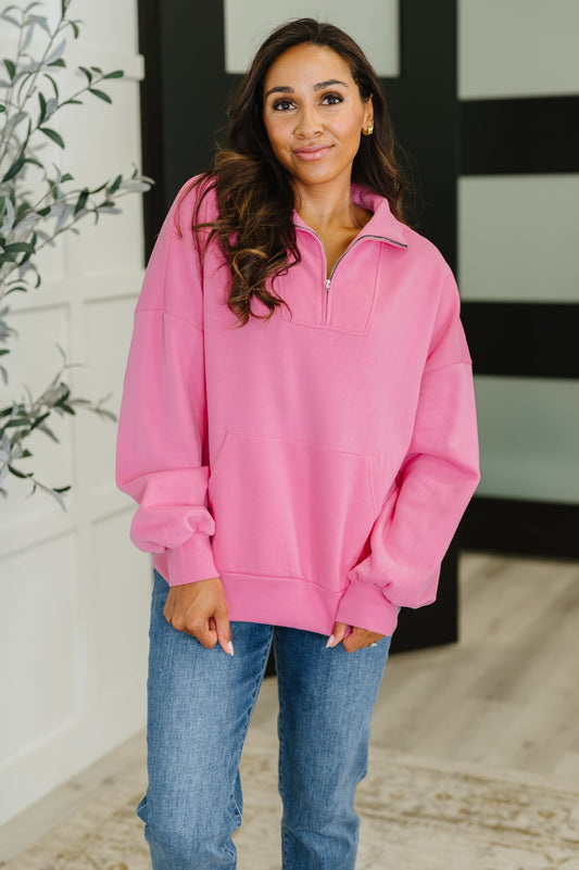 Model wearing Clarice Pink Half Zip Pullover, fleece fabric with high neckline and kangaroo pocket