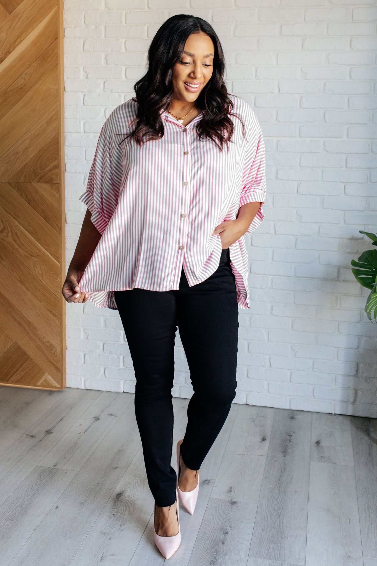 Women's button-up shirt in hot pink with white stripes, featuring a collared neckline, short dolman sleeves, banded cuffs, button closure, and a scooped hemline.