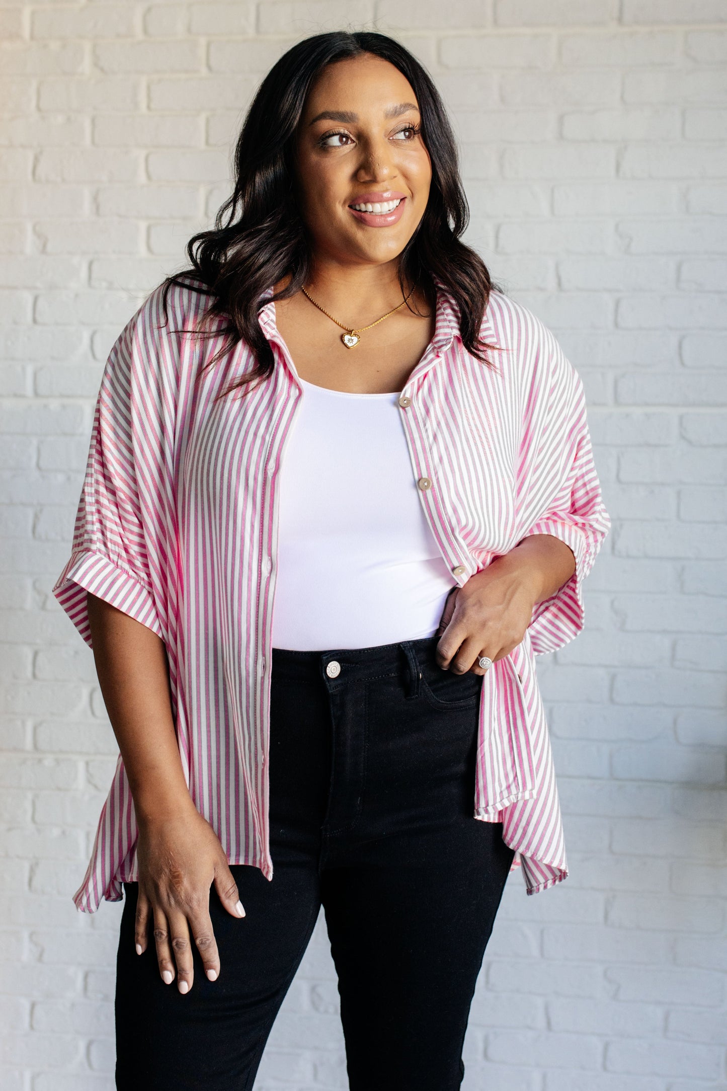 Women's button-up shirt in hot pink with white stripes, featuring a collared neckline, short dolman sleeves, banded cuffs, button closure, and a scooped hemline.