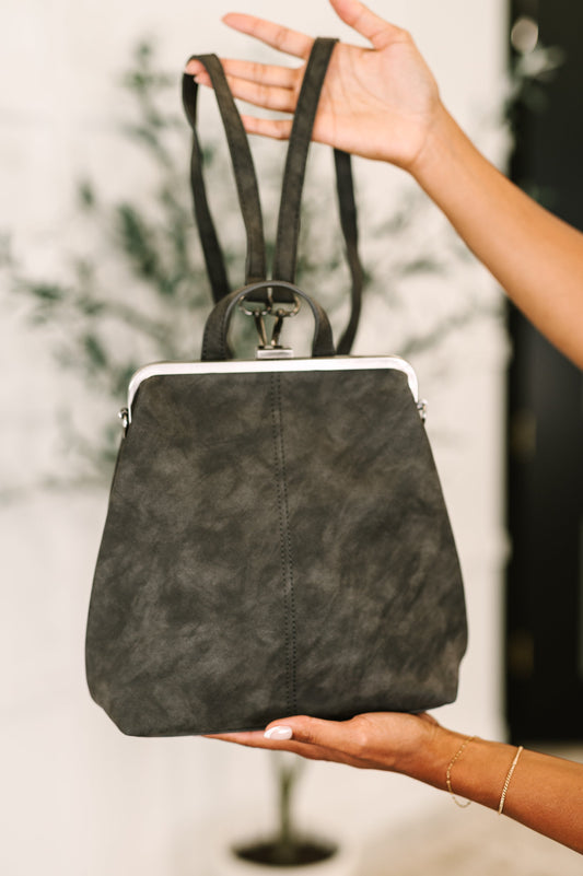 Bridget Backpack in charcoal vegan leather with brass clasp, front view.