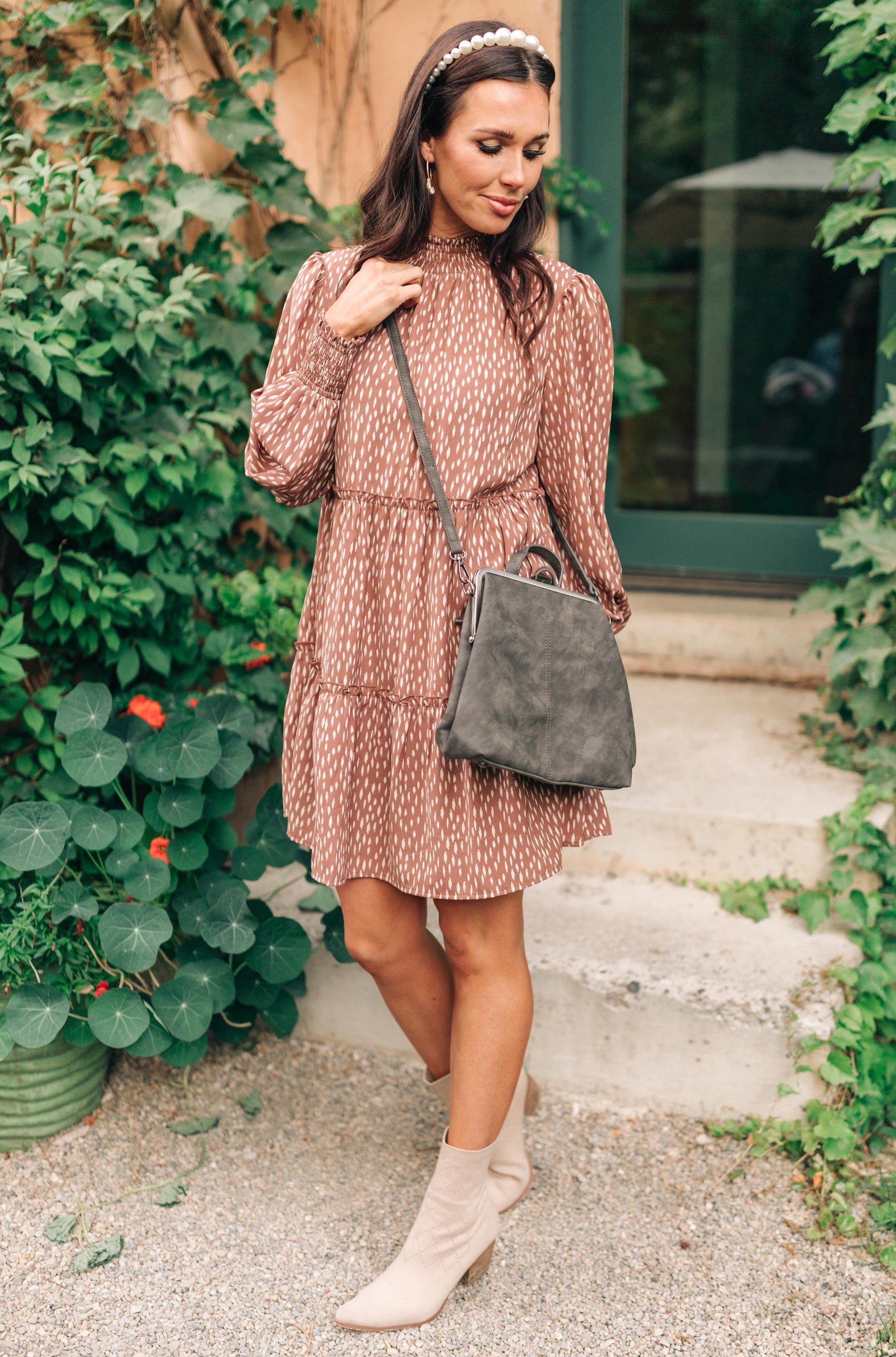 Woman wearing the Bridget Mini Charcoal Backpack crossbody style.