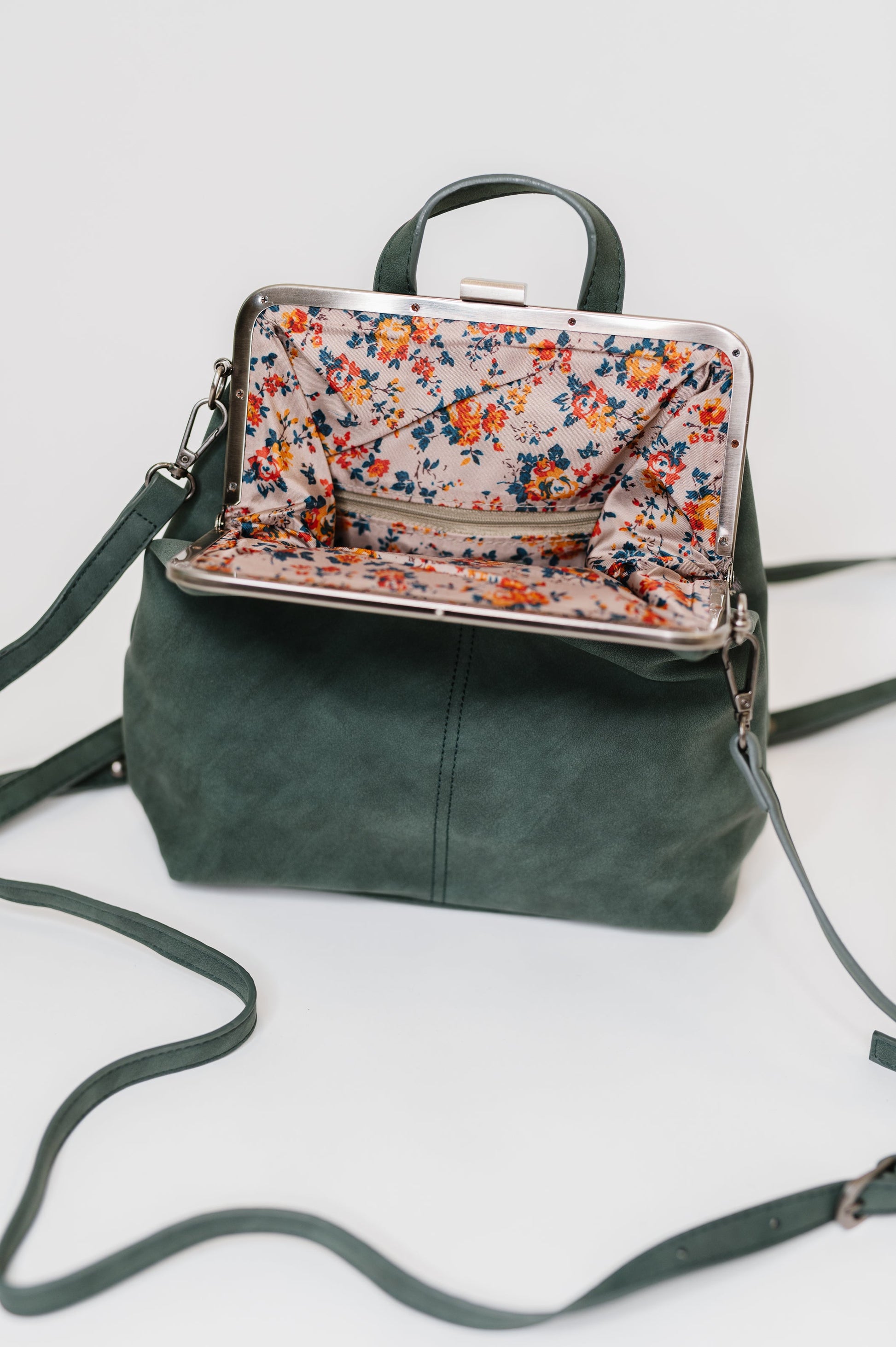 Open Bridget Backpack in Peacock, floral printed lining visible inside.