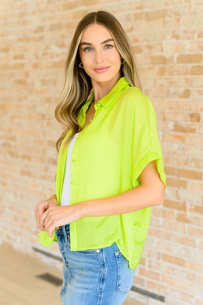 Woven yellow button down shirt with side slits and modern drop shoulder design for everyday wear.