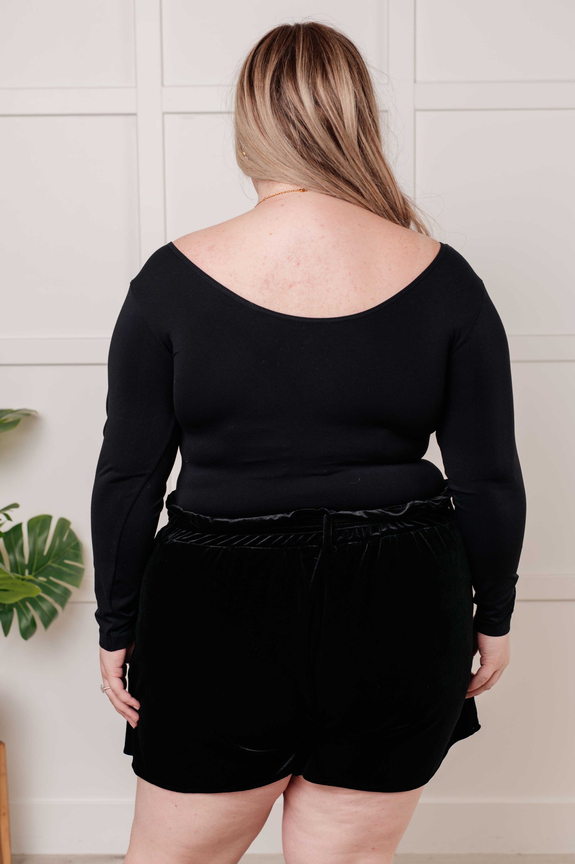 Black long-sleeve reversible top with a scoop and V-neckline, made from soft brushed microfiber in a form-fitting silhouette.