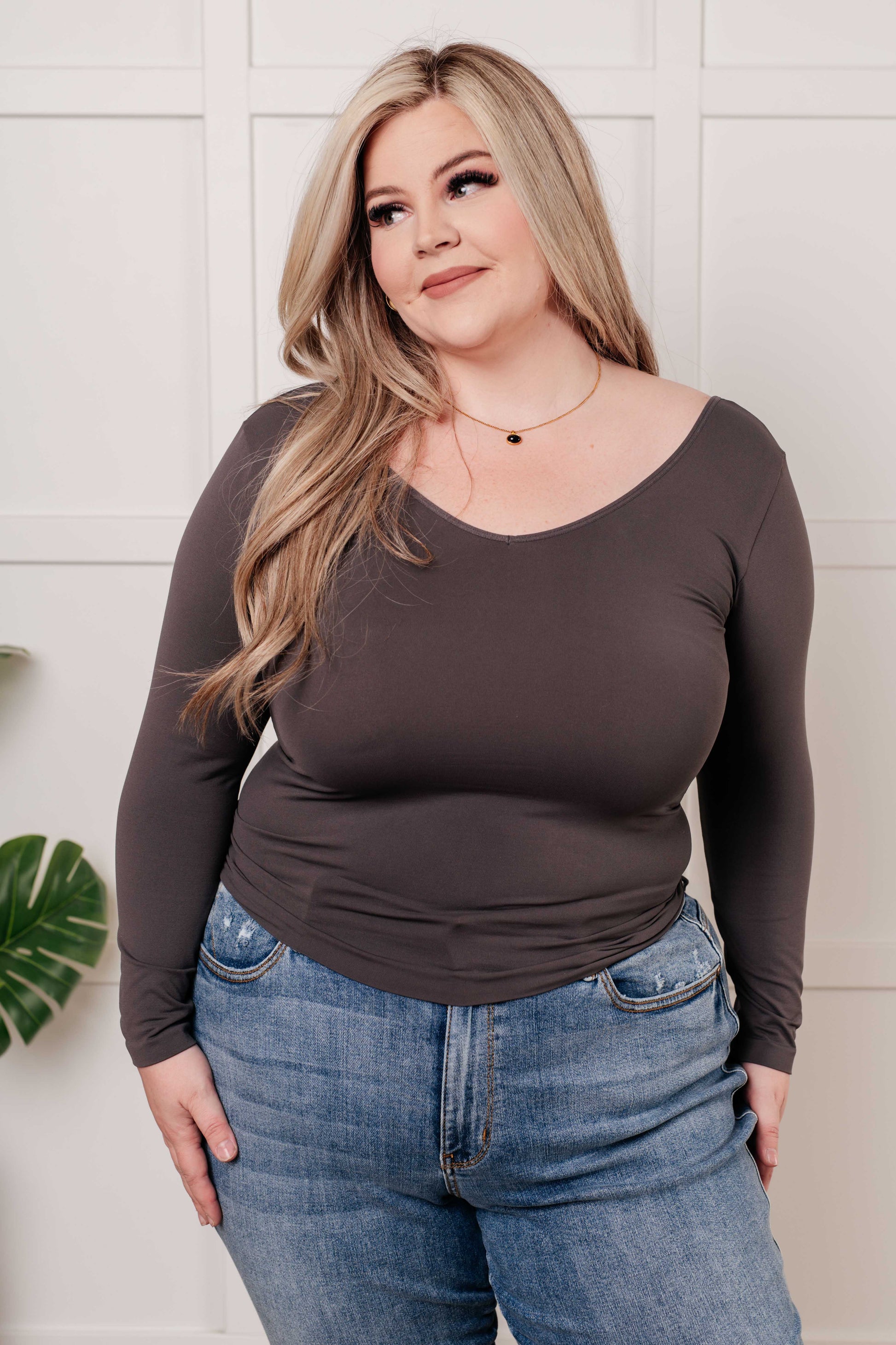 Charcoal long-sleeve reversible top with a scoop and V-neckline, made from soft brushed microfiber in a form-fitting silhouette.