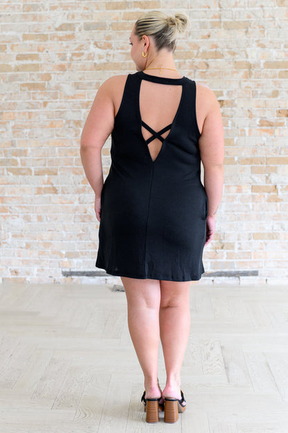 Back view plus size Brynlee black dress, sleeveless with crisscross cut-out detail.