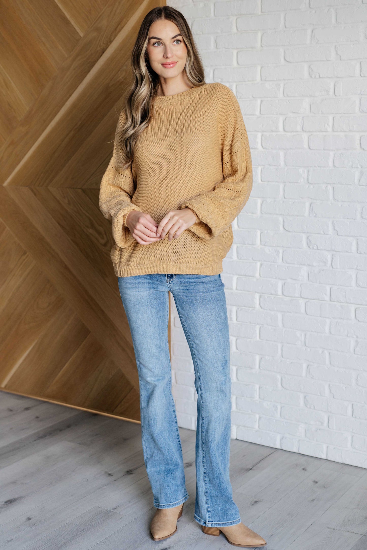 Women's wheat-colored sweater made of sweater knit fabric, featuring a round neckline, long balloon sleeves with drop shoulders, and banded ribbed cuffs, neckline, and hem.