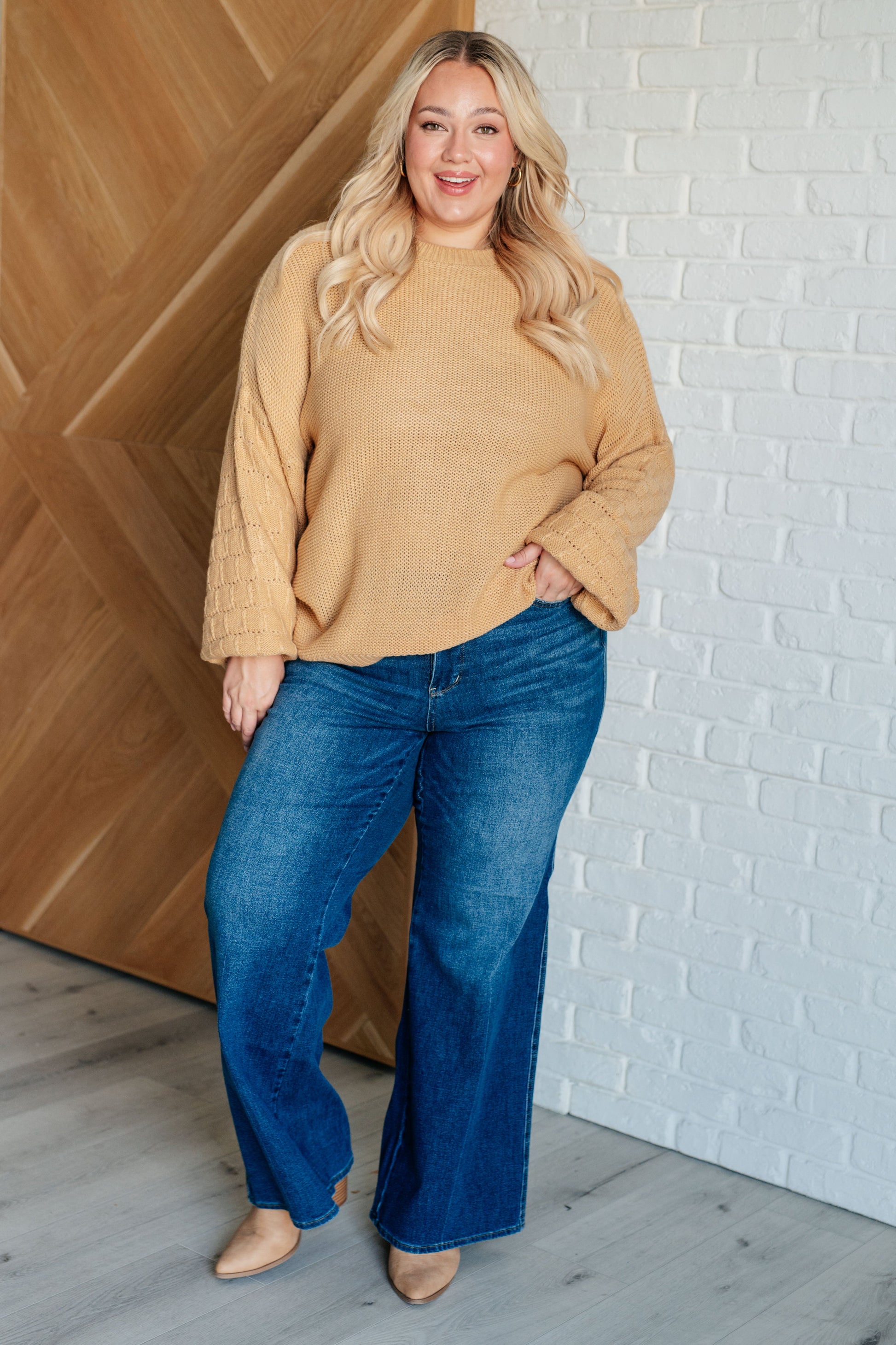 Women's wheat-colored sweater made of sweater knit fabric, featuring a round neckline, long balloon sleeves with drop shoulders, and banded ribbed cuffs, neckline, and hem.