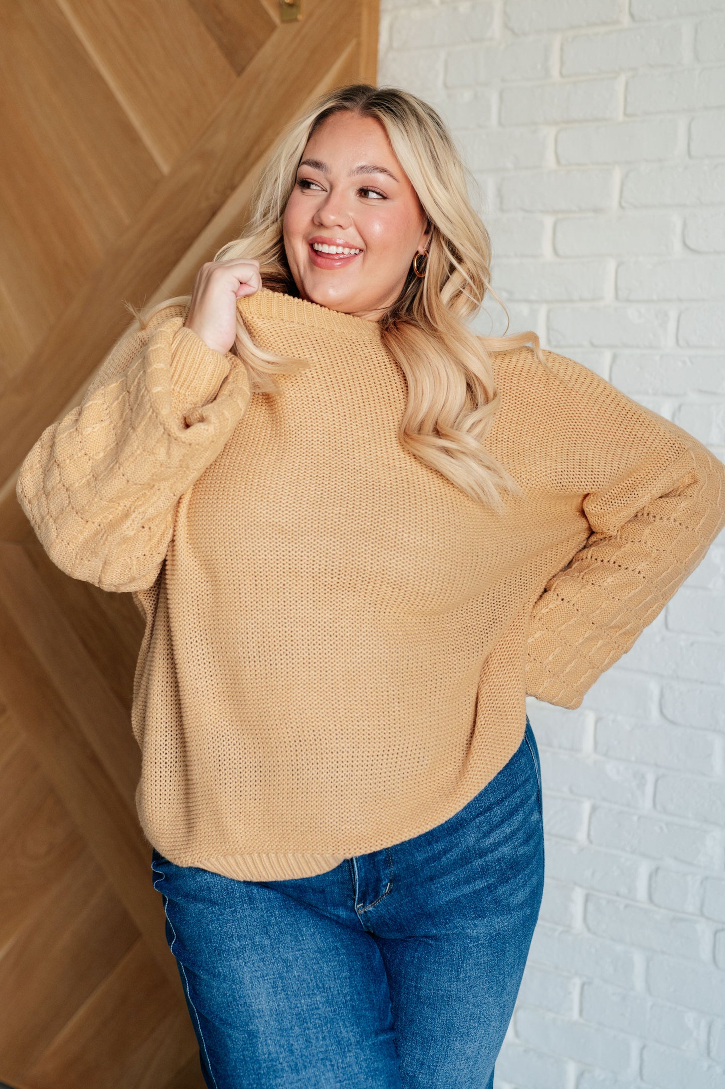 Women's wheat-colored sweater made of sweater knit fabric, featuring a round neckline, long balloon sleeves with drop shoulders, and banded ribbed cuffs, neckline, and hem.