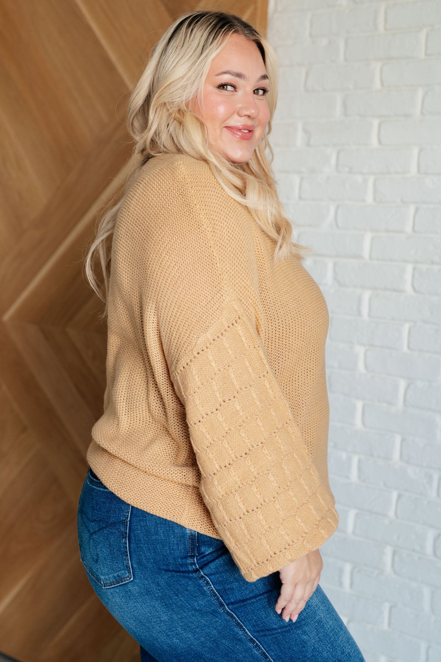 Women's wheat-colored sweater made of sweater knit fabric, featuring a round neckline, long balloon sleeves with drop shoulders, and banded ribbed cuffs, neckline, and hem.