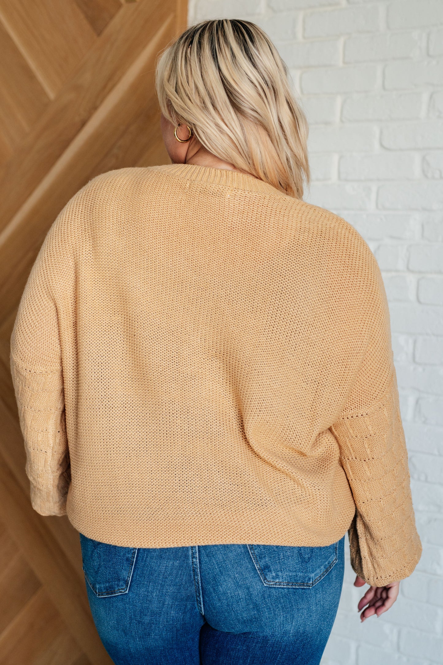 Women's wheat-colored sweater made of sweater knit fabric, featuring a round neckline, long balloon sleeves with drop shoulders, and banded ribbed cuffs, neckline, and hem.